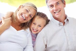 family smiling | Insurance at Dental Care Studios