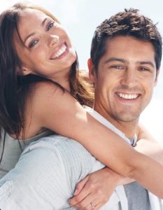 young smiling couple - Dental Implants